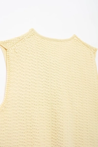 Close-up of pale yellow knit vest showing detailed texture and ribbed V-neckline