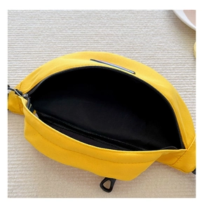 Detail view of yellow canvas waist bag interior with black lining and zipper pocket