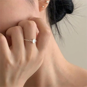 S925 silver chain ring with oval white crystal gemstone on a model's hand