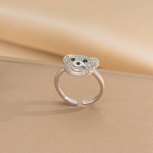 Macro shot of silver bear ring featuring sparkling clear stones and black gem eyes