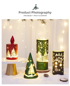 Close-up of hollowed-out Christmas LED candles with snowflake and deer patterns