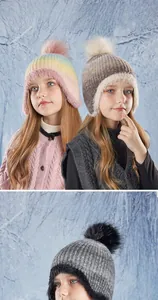 Detailed view of colorful winter knit hat for kids with fluffy pompom and faux fur lining