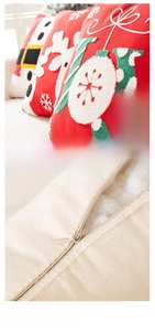 Detail of Christmas pillow cover featuring 'JOY' embroidery and a hidden zipper