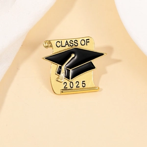 Detail showing the golden Class of 2025 graduation cap enamel pin on a soft background
