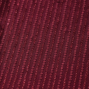 Makro-Detail von weinrotem Paillettenstoff auf Netzbasis für ein rückenfreies Kleid