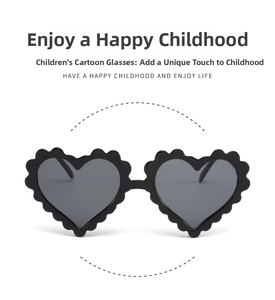 Close-up of black heart-shaped kids sunglasses with unique wavy edge design and dark lenses
