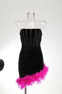 Detail of corset structure and hot pink feather hem on the black mini party dress