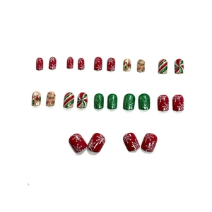Christmas themed press-on nails with red green snowflakes and candy cane holiday patterns