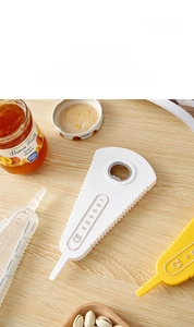 Macro shot of multifunctional bottle opener with wavy non-slip edges on wooden table