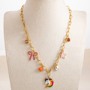 Detail of gold chain necklace with colorful unicorn, butterfly, and heart charms
