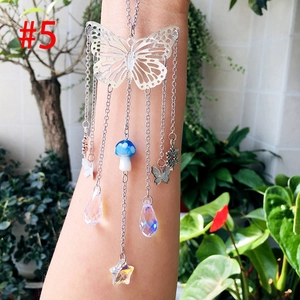 Detail of butterfly suncatcher with colorful crystal prisms and mushroom charm hanging