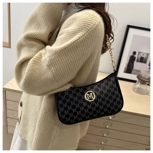 Detail of hobo shoulder bag with M-pattern print and gold metallic ring logo