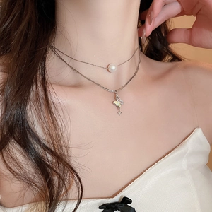 Double-layer silver necklace with pearl and butterfly star pendant on female model