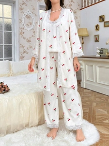 Close-up of cherry print loungewear featuring vertical rib texture and white lace trim