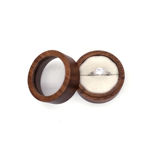 Macro detail of walnut wood ring box with transparent lid and plush velvet lining