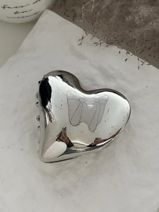 Polished silver heart metal hair claw clip with mirror finish on white background