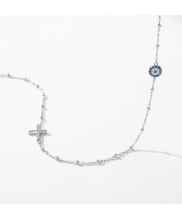 Detail of S925 silver necklace with sparkling cross and blue devil's eye pendants
