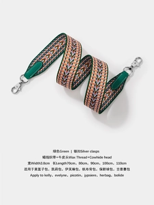 Detail of green and orange wax thread woven wide shoulder strap with silver metal hooks
