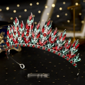 Macro view of a luxury silver crown featuring red and green rhinestones and hair clips
