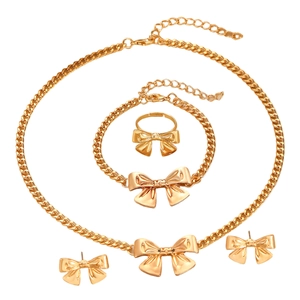 Elegant gold bow jewelry set with adjustable ring, necklace, bracelet and stud earrings