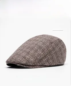 Detail view of khaki checkered texture and flat cap brim on a padded winter beret