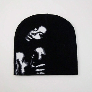 Black knit beanie featuring white pixelated figure pattern on a clean white background