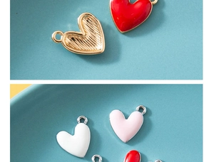 Macro detail of heart-shaped enamel alloy charms with gold finish for DIY jewelry