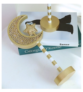 Detail of gold metal moon and star ornaments with intricate hollow carved patterns