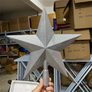 Detail of silver glittery five-pointed star tree topper for Christmas tree decoration