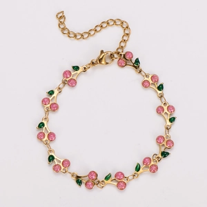 Detail of bohemian cherry charm bracelet with pink glitter and green enamel leaves