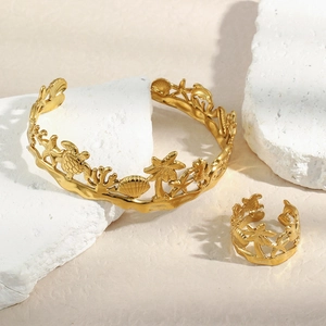Detailed macro view of 18K gold-plated ocean theme jewelry set with hollow coral designs