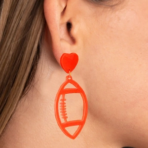 Red heart and rugby ball acrylic earrings for women in a professional model shot