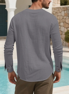 Back view of men's casual grey linen long sleeve shirt in a Mediterranean outdoor setting