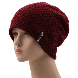Burgundy fleece-lined knit beanie with diamond pattern and black brand label by REALM