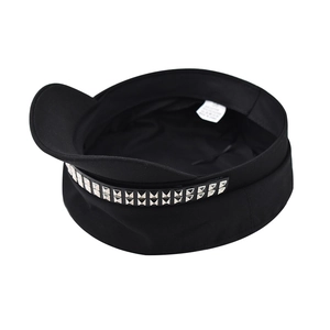 Close-up of black cotton newsboy cap featuring double rows of silver square studs