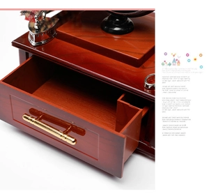 Detail of vintage sewing machine music box with wooden finish and golden drawer handle