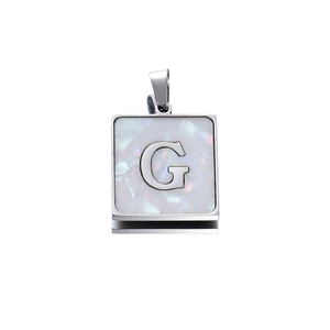 Macro shot of 22mm square silver stainless steel pendant with white shell letter G