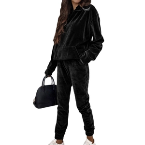 Women black velvet lounge set with oversized hoodie and joggers in minimalist studio shot