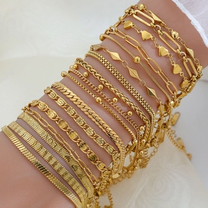 Detail of 18K gold-plated titanium steel chain set featuring heart pendant and snake link