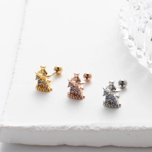 Detailed macro view of carousel screw back earrings in gold, rose gold and silver metal