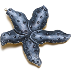 Close-up of a starfish pendant with dark textured inlay, gold edges and a hanging loop