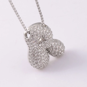 Macro shot of silver pendant with clear cubic zirconia stones on a delicate chain