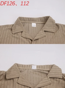 Detailed view of khaki ribbed texture collar and interior wash label on casual shirt