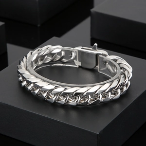 Polished titanium steel Cuban link bracelet for men on a professional black display stand