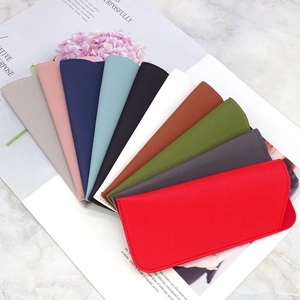 Flat lay of colorful slim PU leather sunglasses pouches arranged in a decorative fan shape