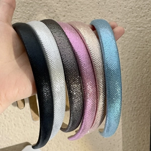 Set of six shimmering glitter headbands in colors like pink, silver, and champagne gold