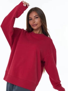 Close-up of red crew neck sweatshirt showing ribbed cuffs and soft cotton knit texture