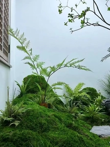 Detailed view of realistic artificial green moss and fern plants for indoor landscaping