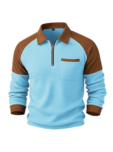Detailed texture of blue waffle knit fabric and brown ribbed collar on men's polo shirt