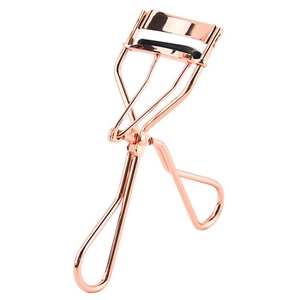 Detail of rose gold eyelash curler with black rubber pad on a white background